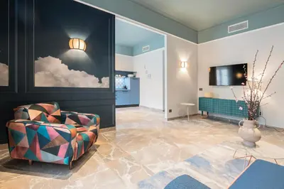 a living room with a chair and a tv at Be Mate Trastevere I in Rome