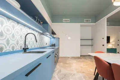 a kitchen with a sink and a table with chairs at Be Mate Trastevere I in Rome