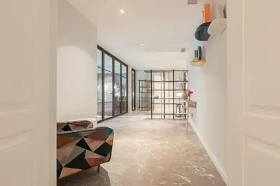 a hallway with a table and a chair at Be Mate Trastevere II in Rome