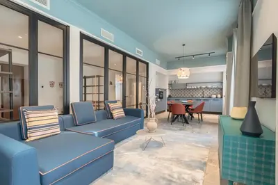 a living room with blue couches and a table at Be Mate Trastevere II in Rome