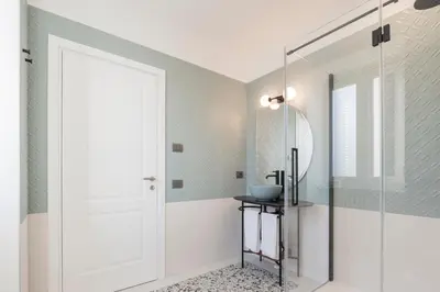 a bathroom with a shower and a glass door at Be Mate Trastevere II in Rome
