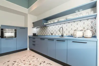 a kitchen with blue cabinets and a sink at Be Mate Trastevere II in Rome