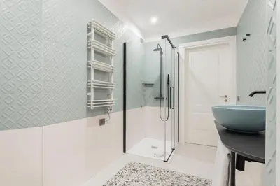 a bathroom with a blue sink and a shower at Be Mate Trastevere III in Rome