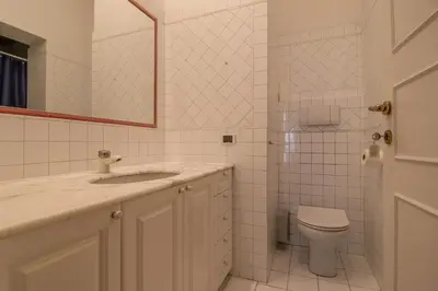 a bathroom with a toilet and a sink and a mirror at Praty Rooms in Rome