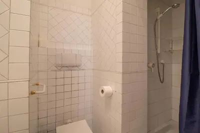 a bathroom with a shower with a toilet and a sink at Praty Rooms in Rome
