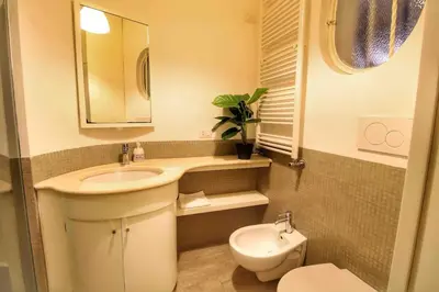 a small bathroom with a sink and a toilet at Cozy Studio Flat in Trastevere by Yourhost in Rome
