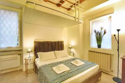 a bedroom with a bed with two towels on it at Cozy Studio Flat in Trastevere by Yourhost in Rome