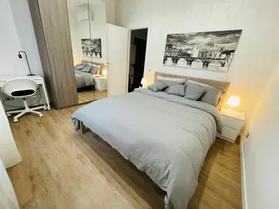 a bedroom with a large bed and a desk at Home Vatican Oasis in Rome