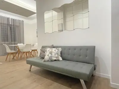 a green couch in a living room with a table at Home Vatican Oasis in Rome