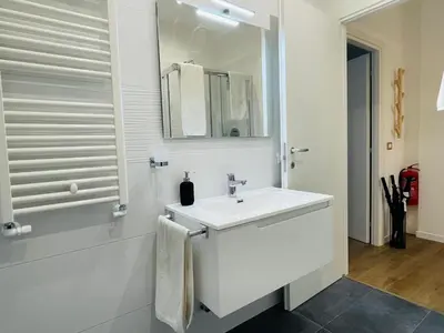 a white bathroom with a sink and a mirror at Home Vatican Oasis in Rome