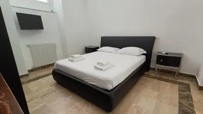 a bedroom with a large bed with white sheets and pillows at Sanniti' Home in Rome