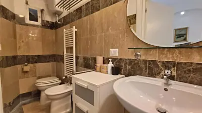 a bathroom with a sink and a toilet and a mirror at Sanniti' Home in Rome