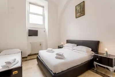 a bedroom with two beds and a window at Sanniti' Home in Rome