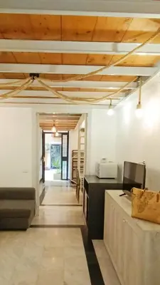 a living room with wooden ceilings and a table at Sanniti' Home in Rome
