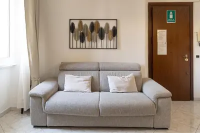 a couch with two pillows in a living room at Vatican Walls Apartment in Rome