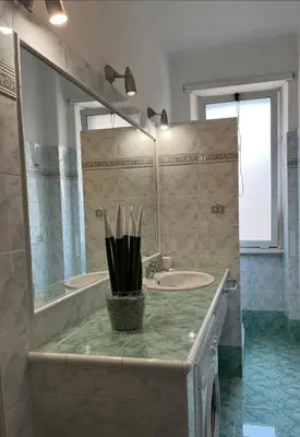 a bathroom with two sinks and a large mirror at Vatican Walls Apartment in Rome