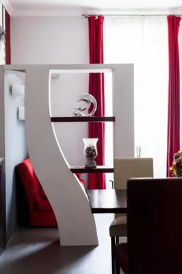 a dining room with a table and red curtains at Attic Vatican Flat - San Pietro in Rome