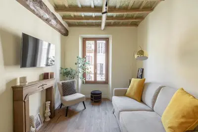 a living room with a couch and a tv at iFlat The Heart of Monti in Rome