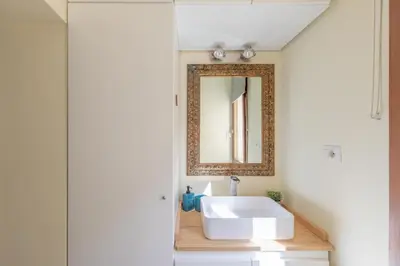a bathroom with a white sink and a mirror at iFlat The Heart of Monti in Rome