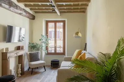 a living room with a couch and a fireplace at iFlat The Heart of Monti in Rome