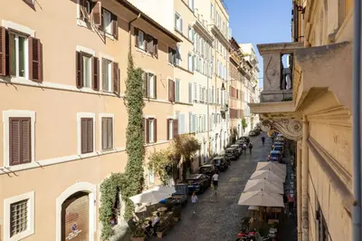 an alley with tables and umbrellas on a city street at iFlat The Heart of Monti in Rome