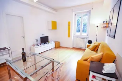 a living room with a couch and a glass table at New Apartment Vatican Museum in Rome