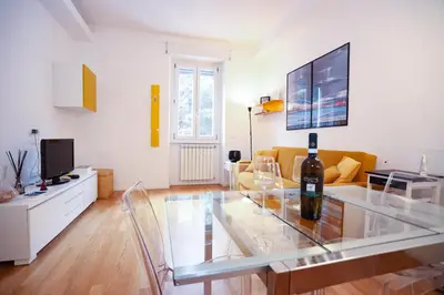 a living room with a glass table and a couch at New Apartment Vatican Museum in Rome