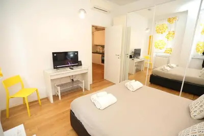 a hotel room with two beds and a television at New Apartment Vatican Museum in Rome