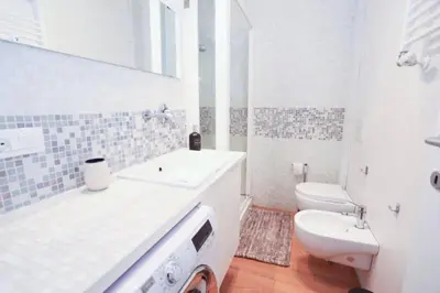 a white bathroom with a sink and a toilet at New Apartment Vatican Museum in Rome