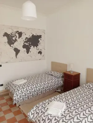 a room with two beds and a map on the wall at Breakfast at St Peter in Rome