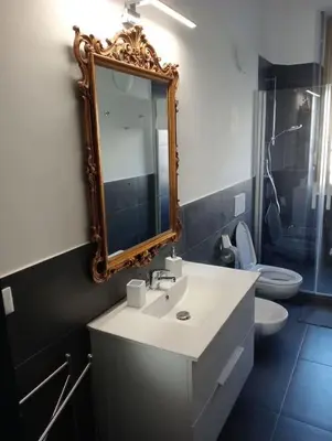 a bathroom with a sink and a mirror and a toilet at Breakfast at St Peter in Rome