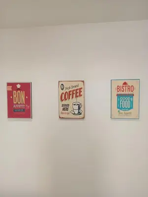 a group of signs hanging on a wall at Breakfast at St Peter in Rome