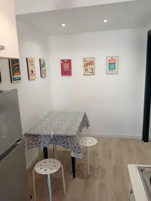 a table and two stools in a kitchen with a table and a table at Breakfast at St Peter in Rome