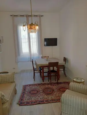 a living room with a table and a couch at Breakfast at St Peter in Rome