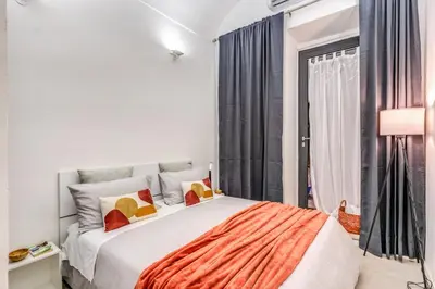 a bedroom with a large bed and a window at Studio Artis Piazza di Spagna in Rome