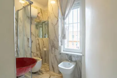 a bathroom with a sink and a toilet and a window at Cipro Roomy House - Vatican in Rome