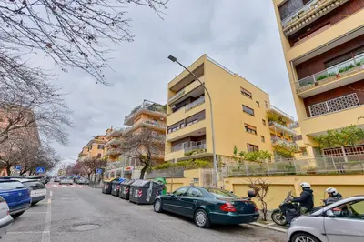 a balcony with a table and chairs and a window at Gold Apartment Monteverde-Gianicolense in Rome