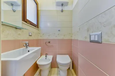 a bathroom with a shower and a toilet and a sink at Gold Apartment Monteverde-Gianicolense in Rome