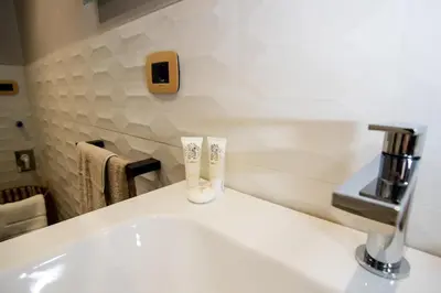 a bathroom with a sink and a faucet at FORNACI 48 GUEST HOUSE in Rome
