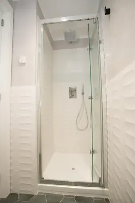 a shower with a glass door in a bathroom at FORNACI 48 GUEST HOUSE in Rome
