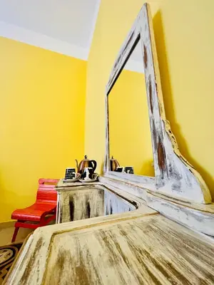 a bathroom with a mirror on a yellow wall at Antonioni's Apartment Trastevere in Rome
