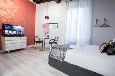 a bedroom with a bed and a table with chairs at Cozy Studio Campo dè Fiori in Rome