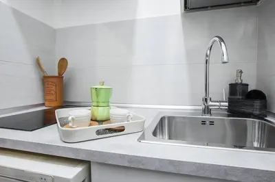 a kitchen counter top with a sink and a counter top at Cozy Studio Campo dè Fiori in Rome
