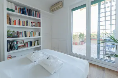 a bedroom with a large white bed with two towels on it at Aventino Terrace in Rome