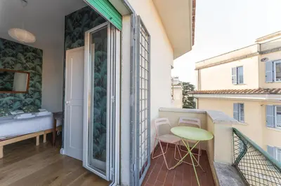 a balcony with a bed and a table and chairs at Aventino Terrace in Rome