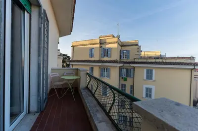 a balcony with a table and a view of a building at Aventino Terrace in Rome