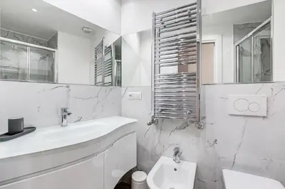 a white bathroom with a sink and a toilet at Apt in the heart of the city in Rome