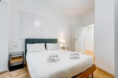 a bedroom with a large white bed with two towels on it at Apt in the heart of the city in Rome