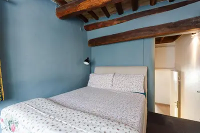 a bedroom with a bed with a blue wall at Pantheon Loft - B in Rome