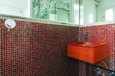 a red tiled bathroom with a sink and a mirror at Pantheon Loft - B in Rome